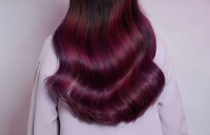 Woman in violet burgundy hair color