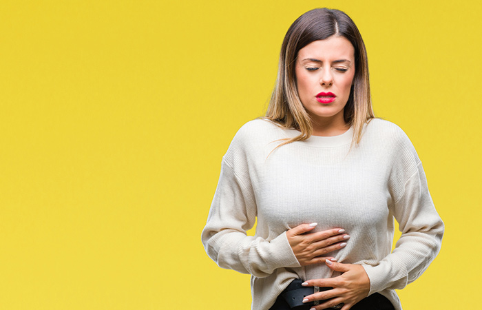 Woman feeling gastrointestinal discomfort