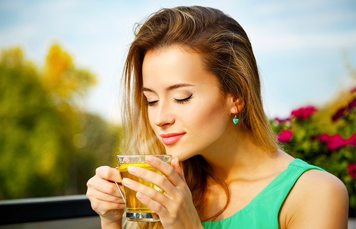 Young woman drinking green tea