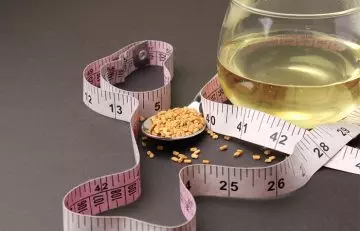 Fenugreek seeds and water with a measuring tape