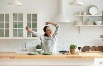 Energetic woman dancing in the kitchen