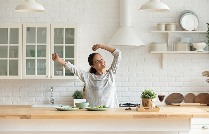 Energetic woman dancing in the kitchen