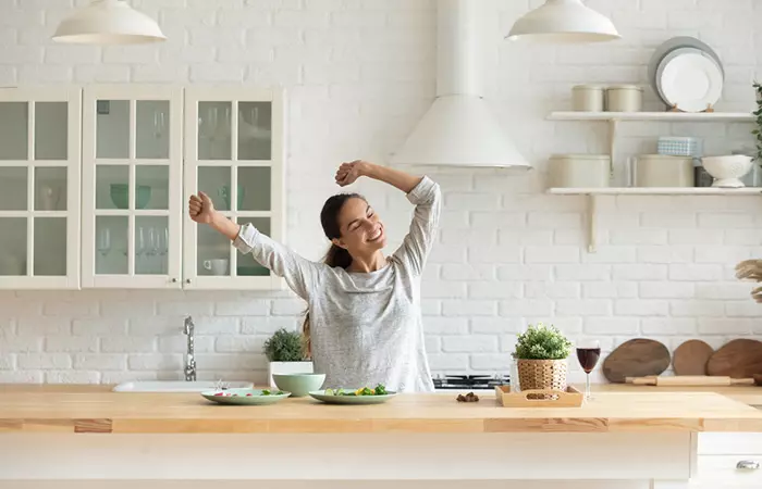 Energetic woman dancing in the kitchen