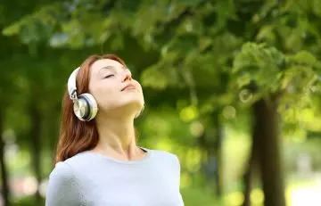Woman listening to music while meditating