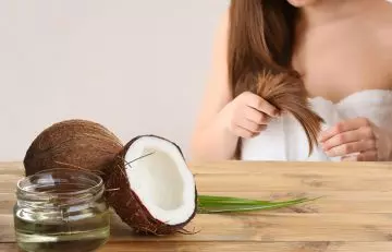 Woman applying coconut oil to the hair