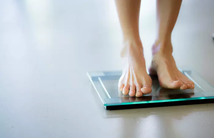 Woman checking weight