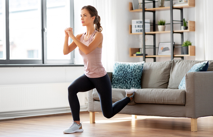 A woman doing couch stretch for tight hip flexors