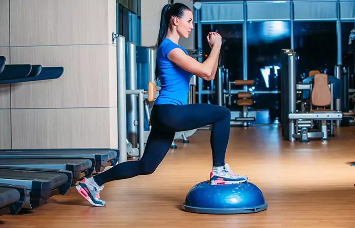 A woman doing the bosu ball lunge exercise