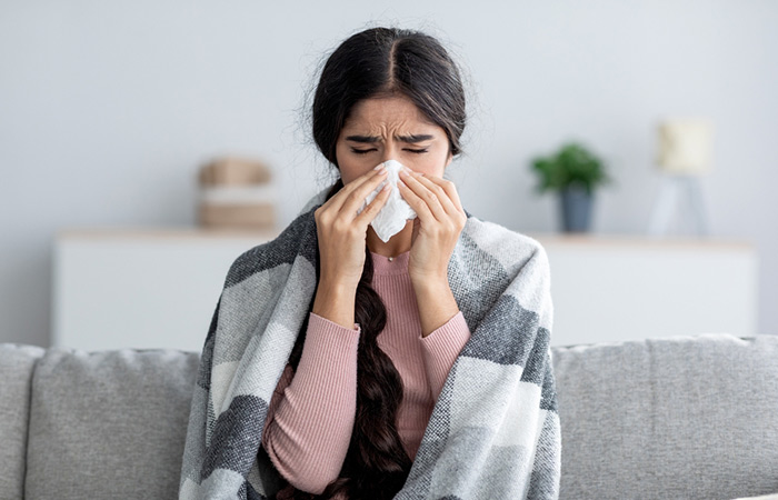 A woman experiencing cold and flu
