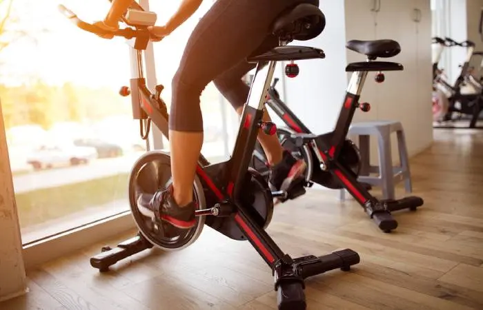 A woman using a stationary exercise bike