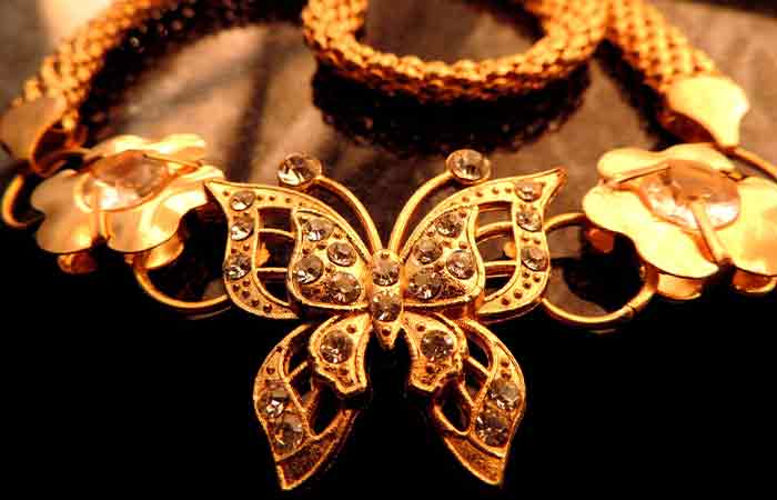 Close up of a golden waist chain with a butterfly motif