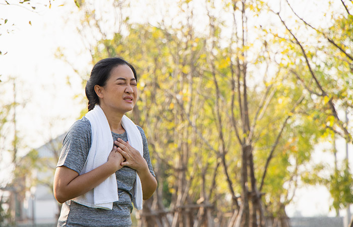 Woman experiencing chest pain after her morning run