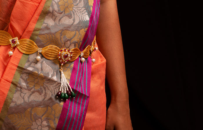 Woman wearing waist chain on saree