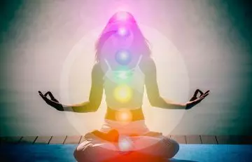 Woman doing meditation to receive cosmic energy