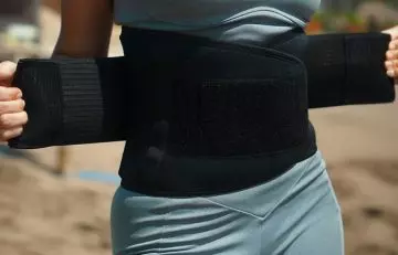 Woman wearing vibrating belts for weight loss outside