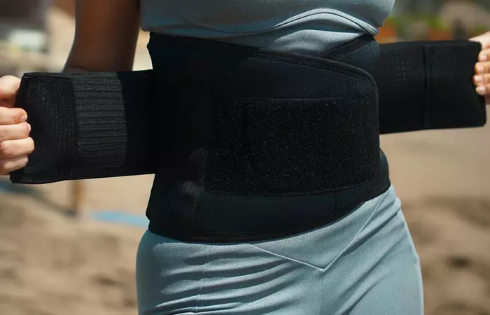 Woman wearing vibrating belts for weight loss outside