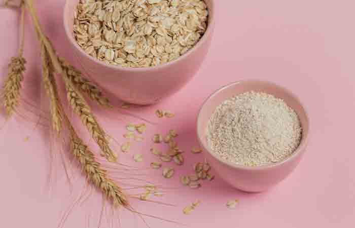 Bowl of dry oat flakes with oatmeal for soft hands