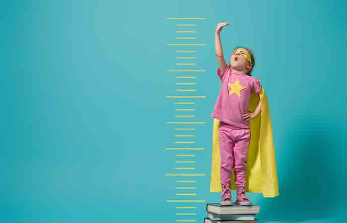 A superhero child measuring height.