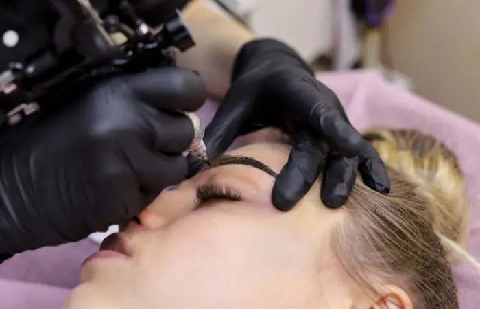 Close-up of an eyebrow tattoo process