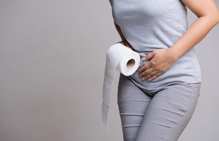 Woman suffering from diarrhea as a side effect of whey protein 