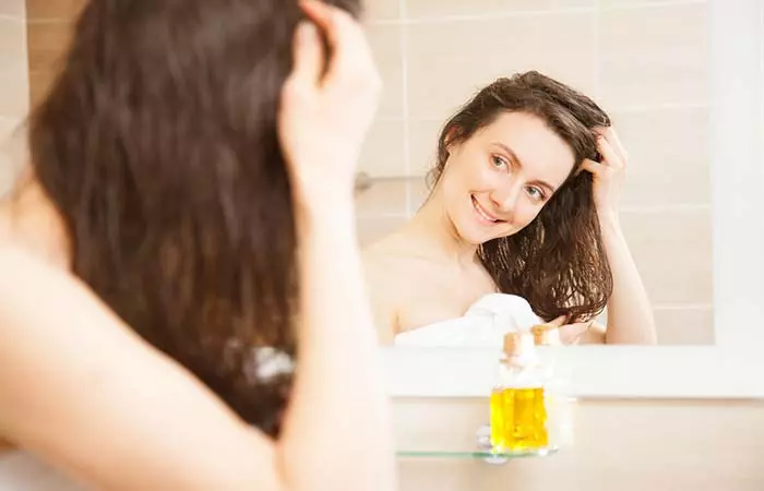 Woman looking at a mirror after shower