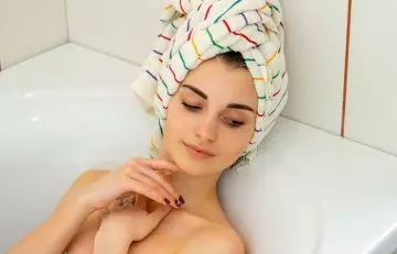 Woman relaxing with a towel in her hair