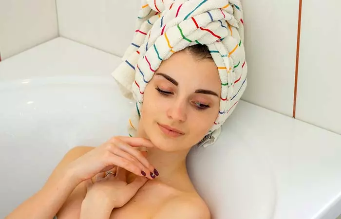 Woman relaxing with a towel in her hair