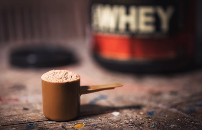 Whey protein in a measuring scoop