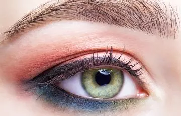 A girl with two color makeup for green eyes