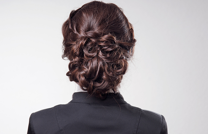 Back view of a girl with curly ends updo hairstyle