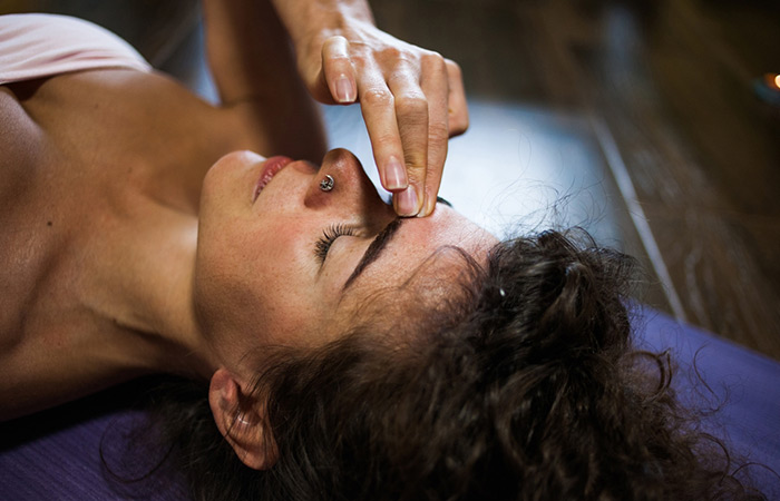Woman massaging the third eye point