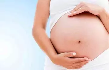 Woman showing her pregnant belly