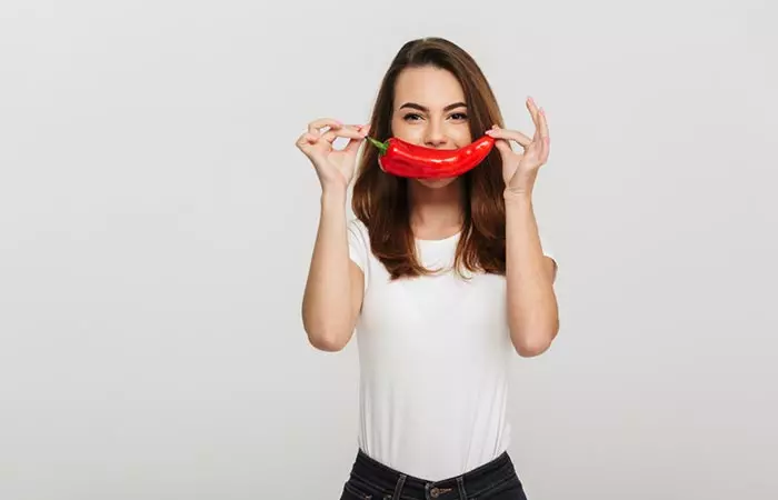 Woman holding a big chili 