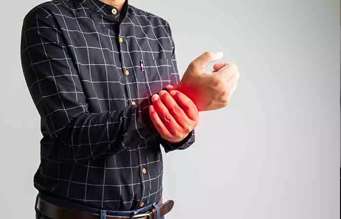 Man holding his hand to show bone weakness