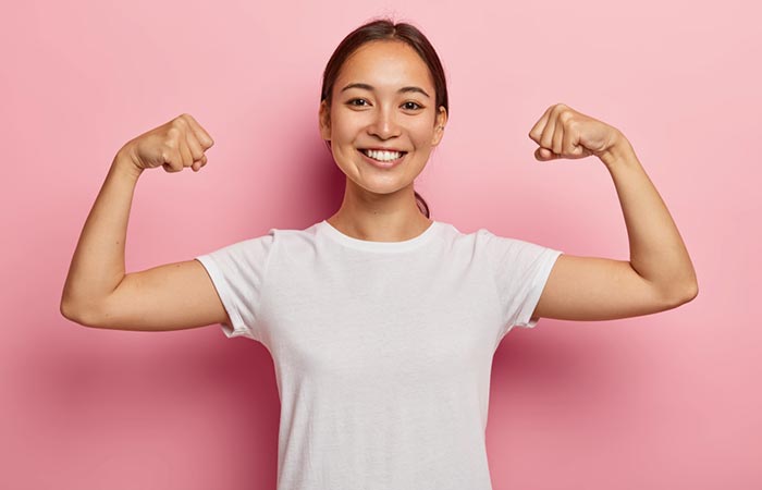 Woman showing her biceps to represent immunity