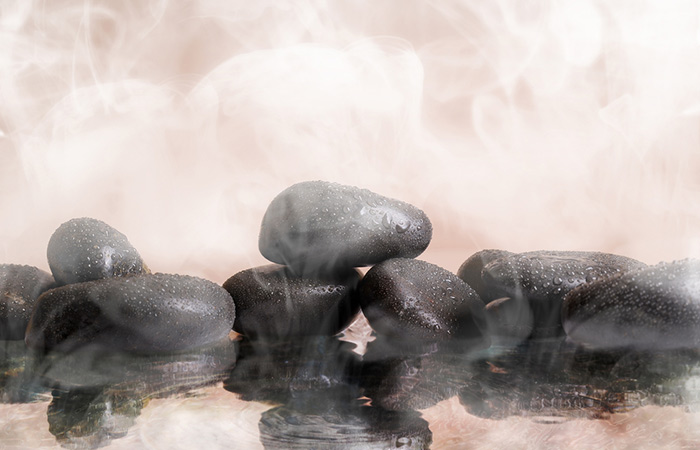 Close up of steam emanating from sauna stones which is great for detoxification
