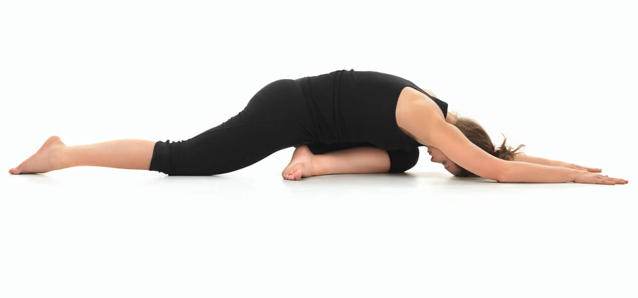 woman doing the pigeon pose in yoga