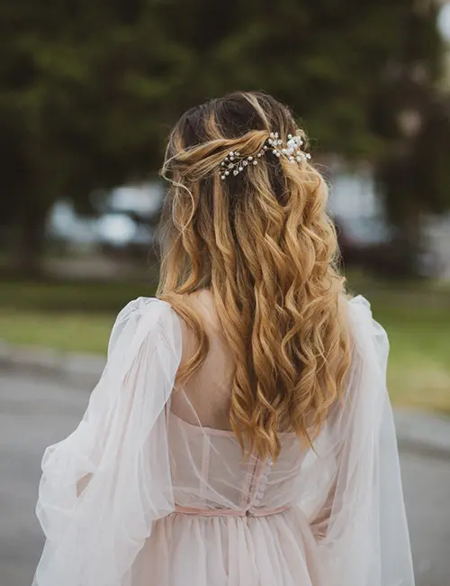  A girl with wavy hair in half up half down hairstyle