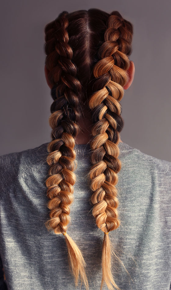 A woman showing a double French braid
