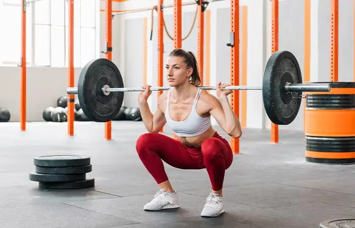 Woman performing barbell squat