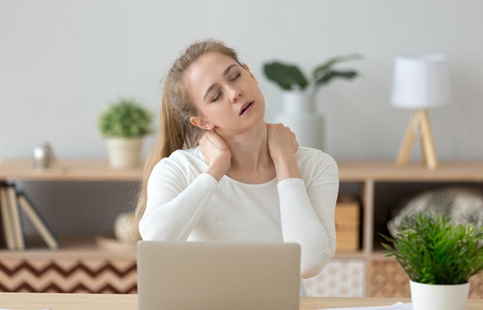 Woman having shoulder pain that reverse prayer pose can relieve