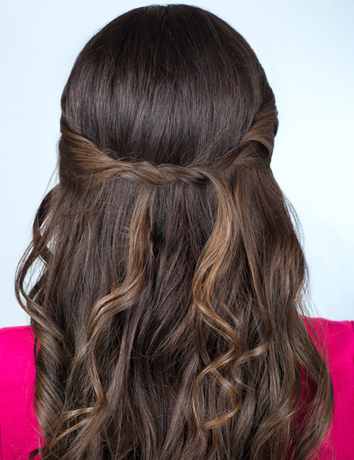 Bouffant half up-half down prom hairstyle with twisted sides