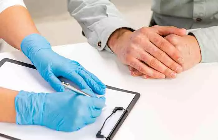 Doctor examines patient's psoriasis condition