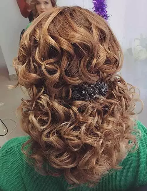 Curly half up-half down ponytail prom hairstyle