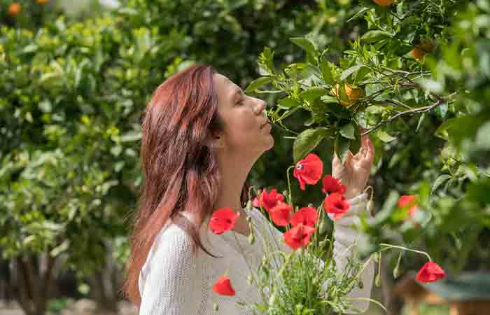 Woman breathing fresh flowers