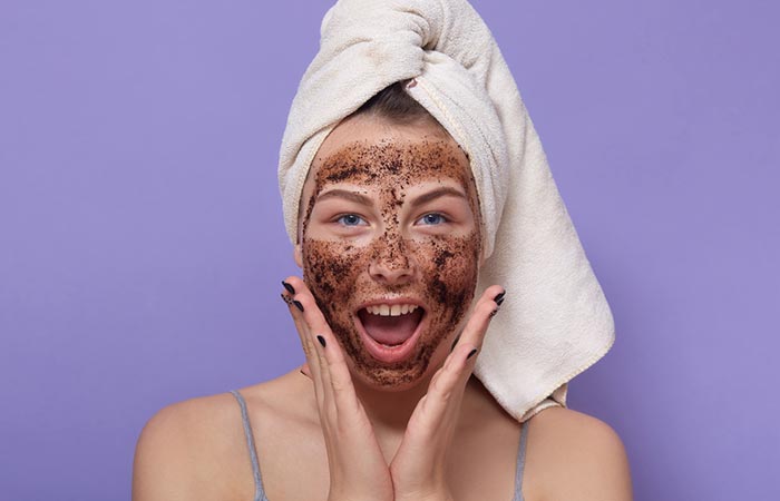 Woman applying a face scrub for glowing and healthy skin