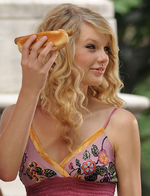 Taylor Swift holding a hotdog