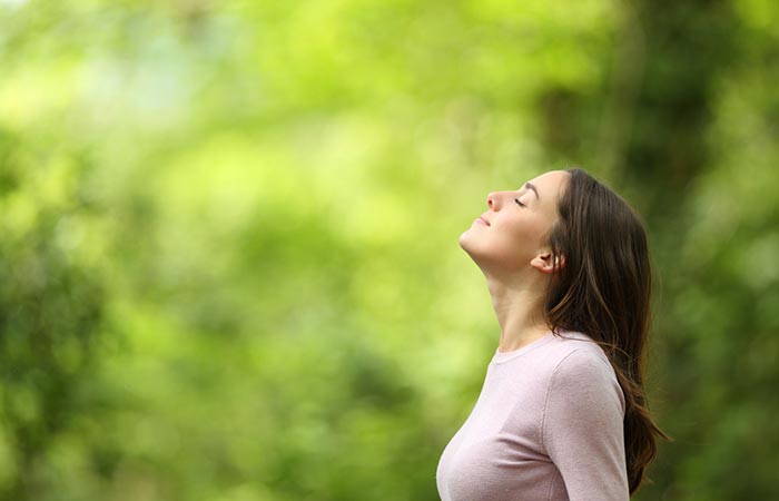 Woman breathing in fresh air to increase oxygen levels.