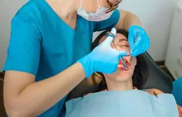 Doctor treating mucoceles by injecting steroids into the cyst in the patient's mouth