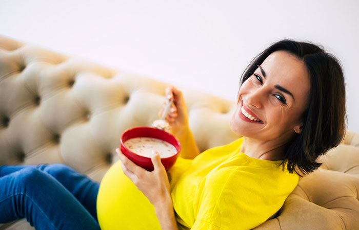 A pregnant woman enjoying a bowl of oatmeal